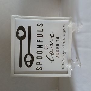 Wall decor,  picture frame.  "Spoonfuls of love added to every recipe " .